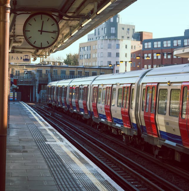 Interior view of Harrow & Wealdstone underground station platform during evening or night, showing brick walls, illuminated signs including 'Harrow & Wealdstone' and station directions, a stainless st